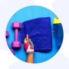 Person holding a blue towel with pink dumbbells on a blue background