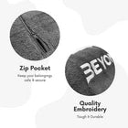 Two grey towels with branding and text about zip pocket and embroidery quality.