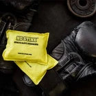 Yellow glove deodoriser next to a black boxing glove.