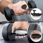 Close-up of hands holding a dumbbell wearing gym grips, with a small inset showing a magnified view of the grip.