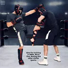 Two men in a boxing ring wearing a headguard and gloves.