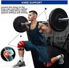 Man performing weighted lunge wearing red knee wraps