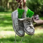 Shoe deodorisers inserted into hanging shoes.