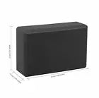 Black yoga block with dimensions indicated