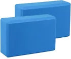 Two blue foam yoga blocks on a white background