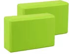 Two green yoga blocks on a white background