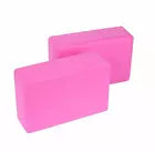 Two pink foam yoga blocks on a white background