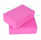 Two pink foam yoga blocks on a white background