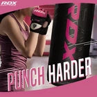 Woman training on heavy bag wearing pink MMA gloves