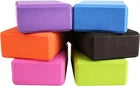 Stack of coloruful foam yoga blocks on a white background